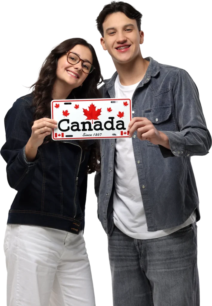Casal de jovens sorrindo segurando uma placa com a palavra Canada